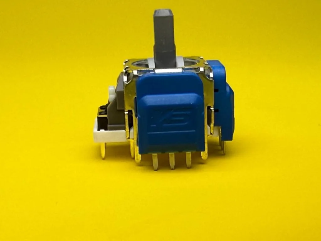Close-up of a blue TMR joystick module on a yellow background