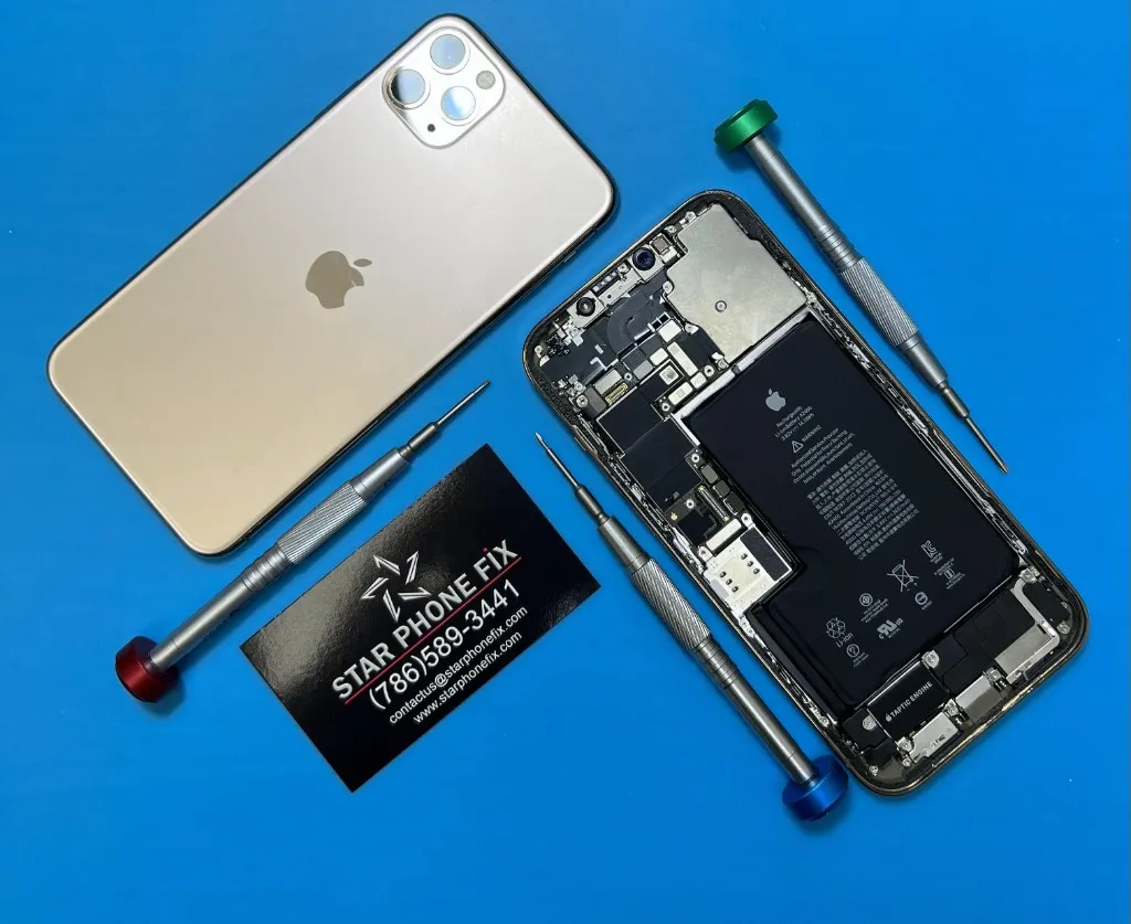 Disassembled iPhone with battery exposed next to a gold iPhone and Star Phone Fix precision tools